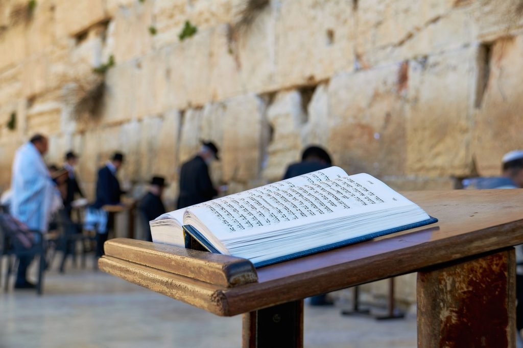 36111121 - western wall also known as wailing wall in jerusalem. the bible book in the foreground.