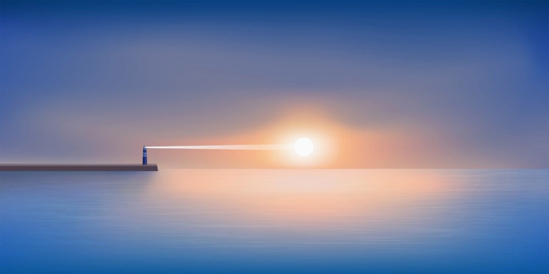 Scenic landscape showing a lighthouse at sunrise with the sun appearing at the horison.